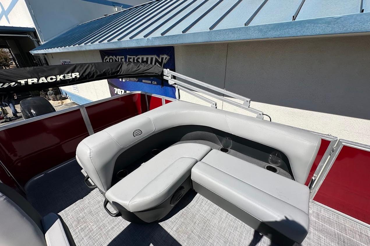 2026 Sun Tracker Party Barge 18 DLX with gray seating and red paneling.