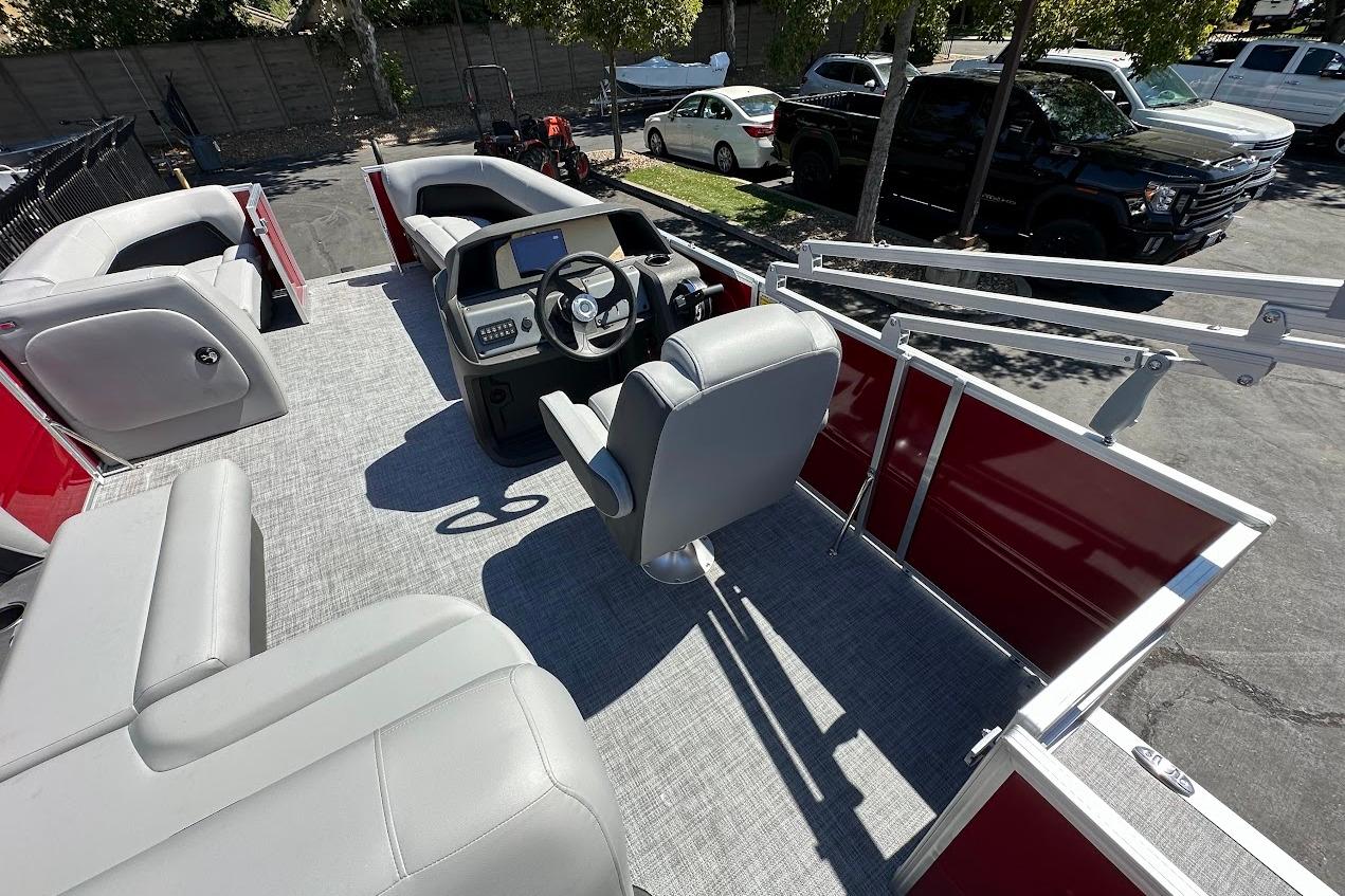 2026 Sun Tracker Party Barge 18 DLX interior with seating and steering console.