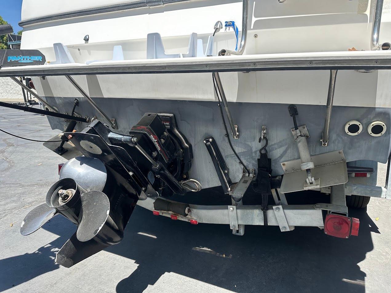 1992 Bayliner 2359 Trophy boat stern with propeller and outboard motor.