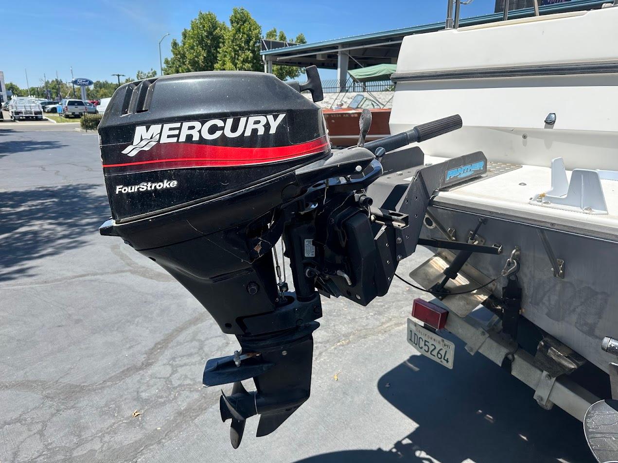 1992 Bayliner 2359 Trophy with Mercury FourStroke outboard motor in a parking lot.