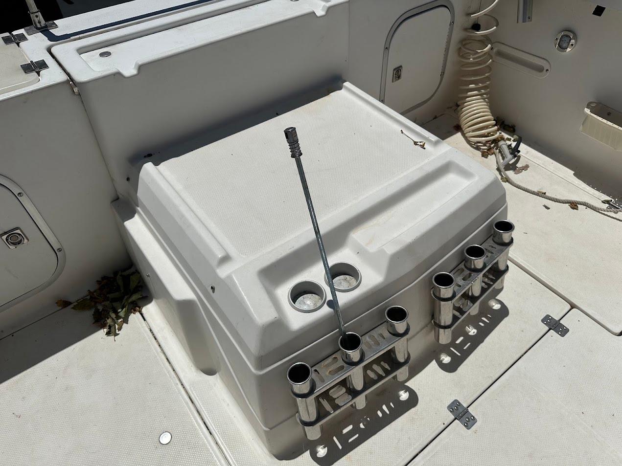 1992 Bayliner 2359 Trophy boat deck with rod holders and storage compartments.
