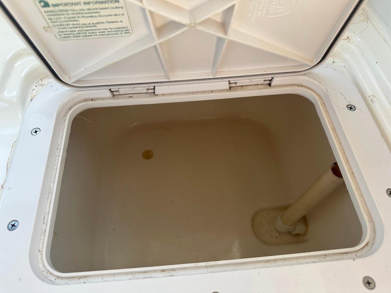 Open storage compartment on 1992 Bayliner 2359 Trophy boat, showing interior details.