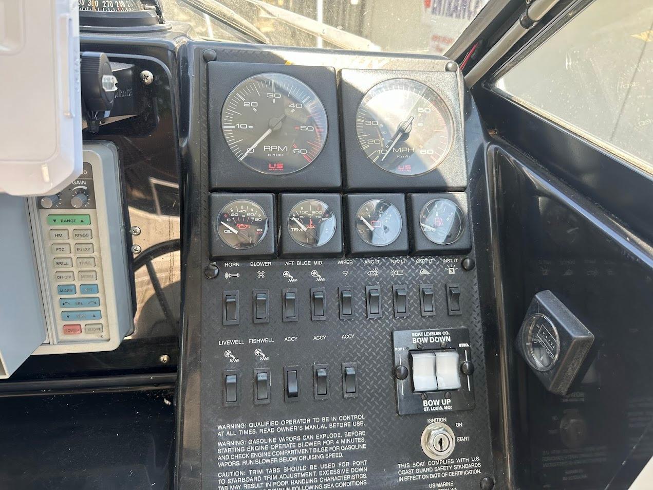 Dashboard of a 1992 Bayliner 2359 Trophy boat with gauges and controls.
