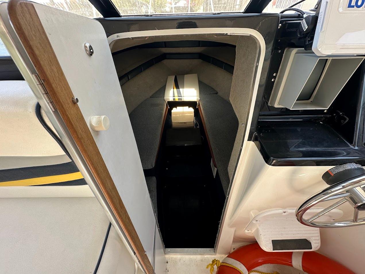 1992 Bayliner 2359 Trophy cabin interior with steering wheel and open door view.