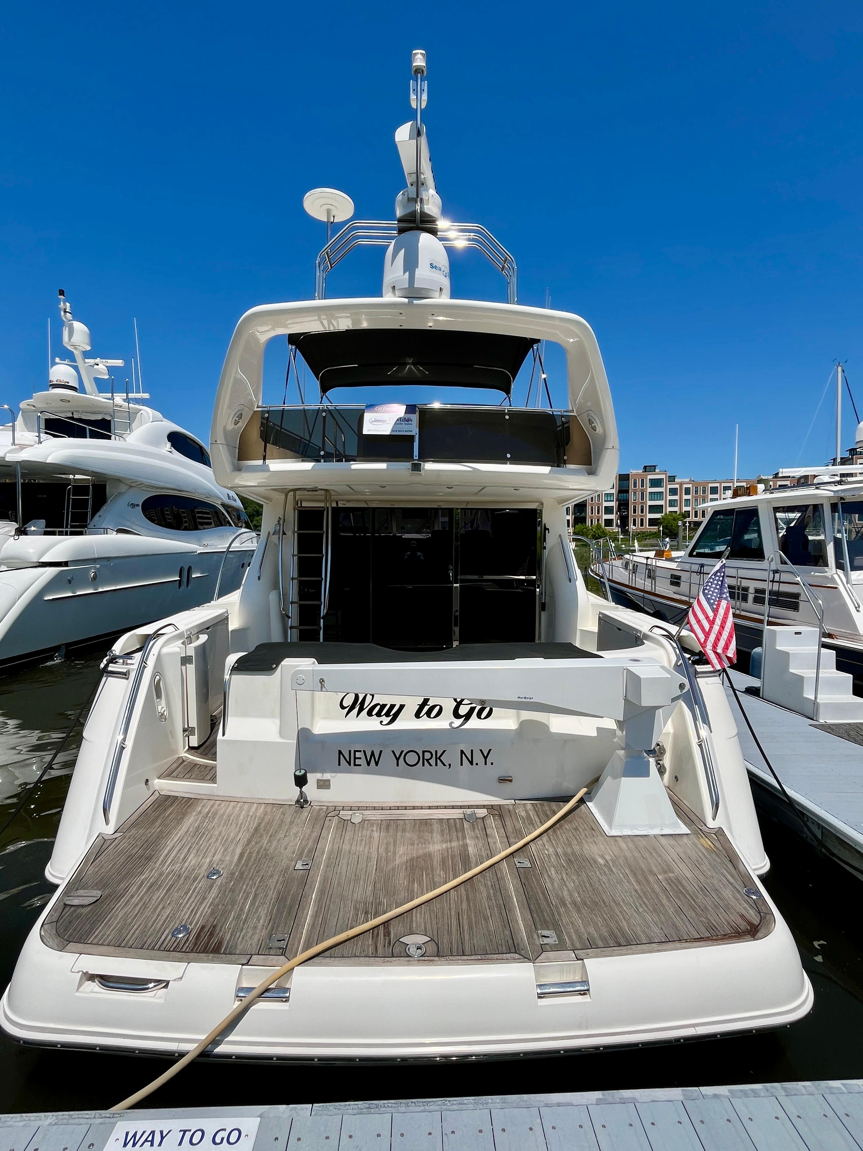 1999 Viking Sport Cruisers 61 Flybridge yacht docked, rear view, with u0022Way to Gou0022 nameplate.