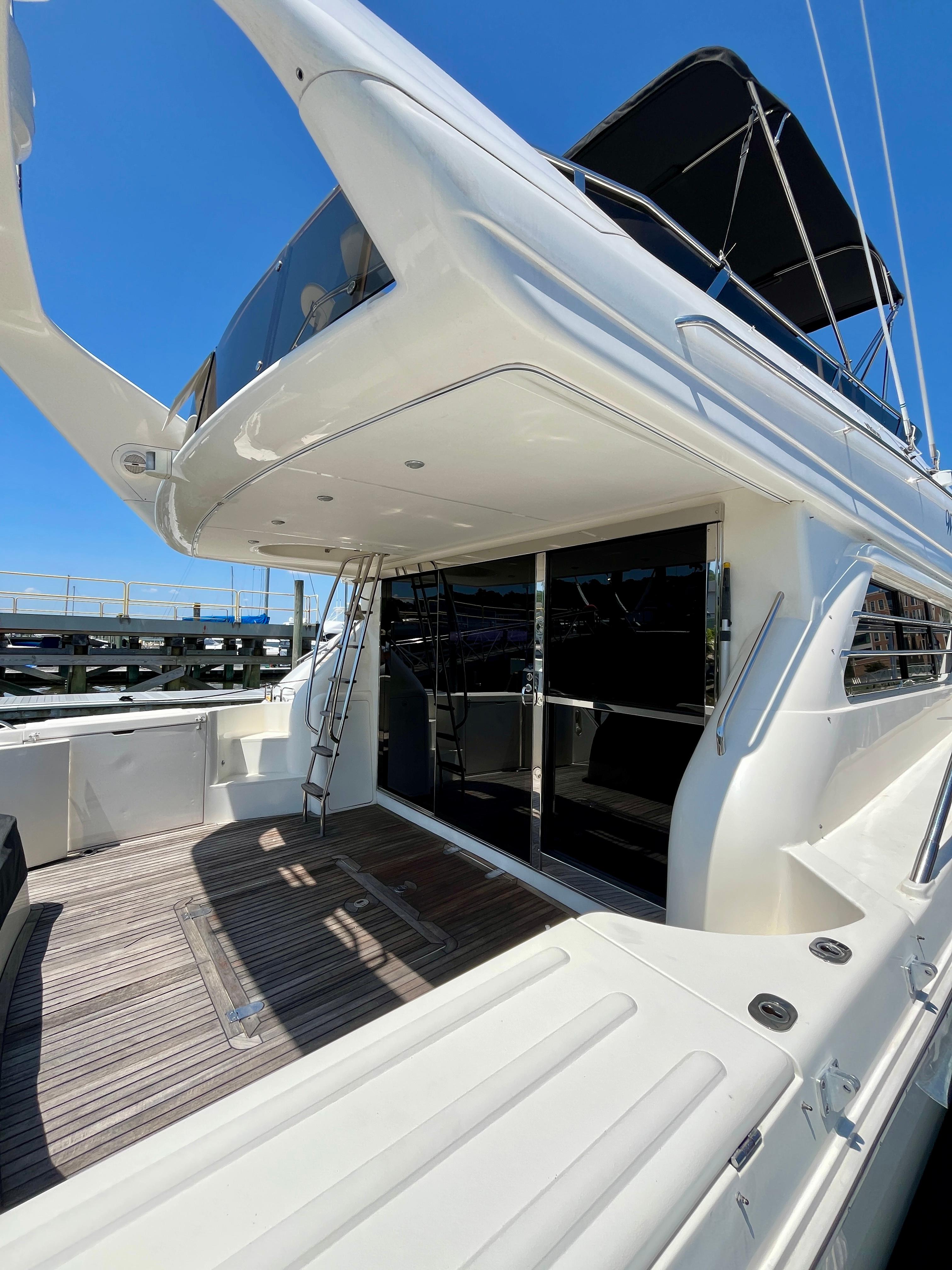 1999 Viking Sport Cruisers 61 Flybridge yacht with spacious deck and sleek design.