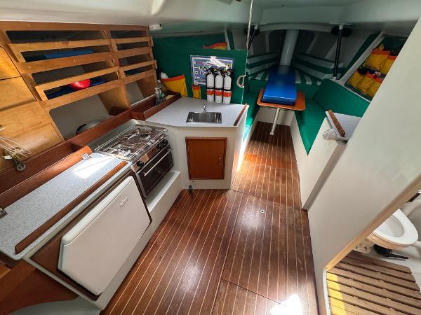 Interior of a 2000 Wyliecat 48 sailboat with kitchen and seating area.