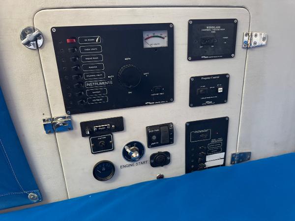 Control panel of a 2000 Wyliecat 48 sailboat with various switches and gauges.