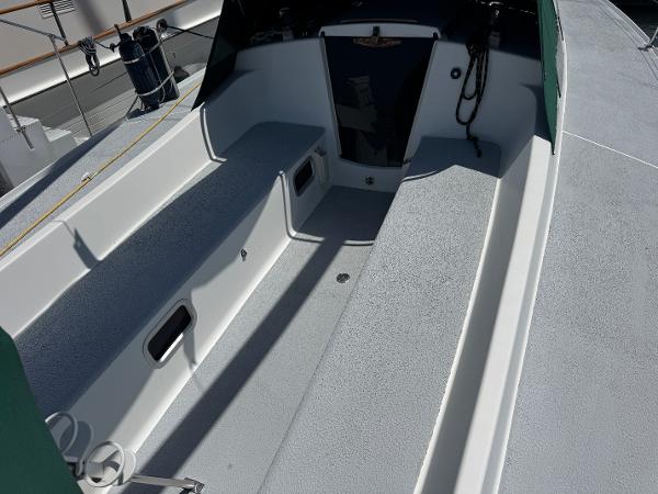 Spacious cockpit of a 2000 Wyliecat 48 sailboat, featuring sleek seating and storage compartments.