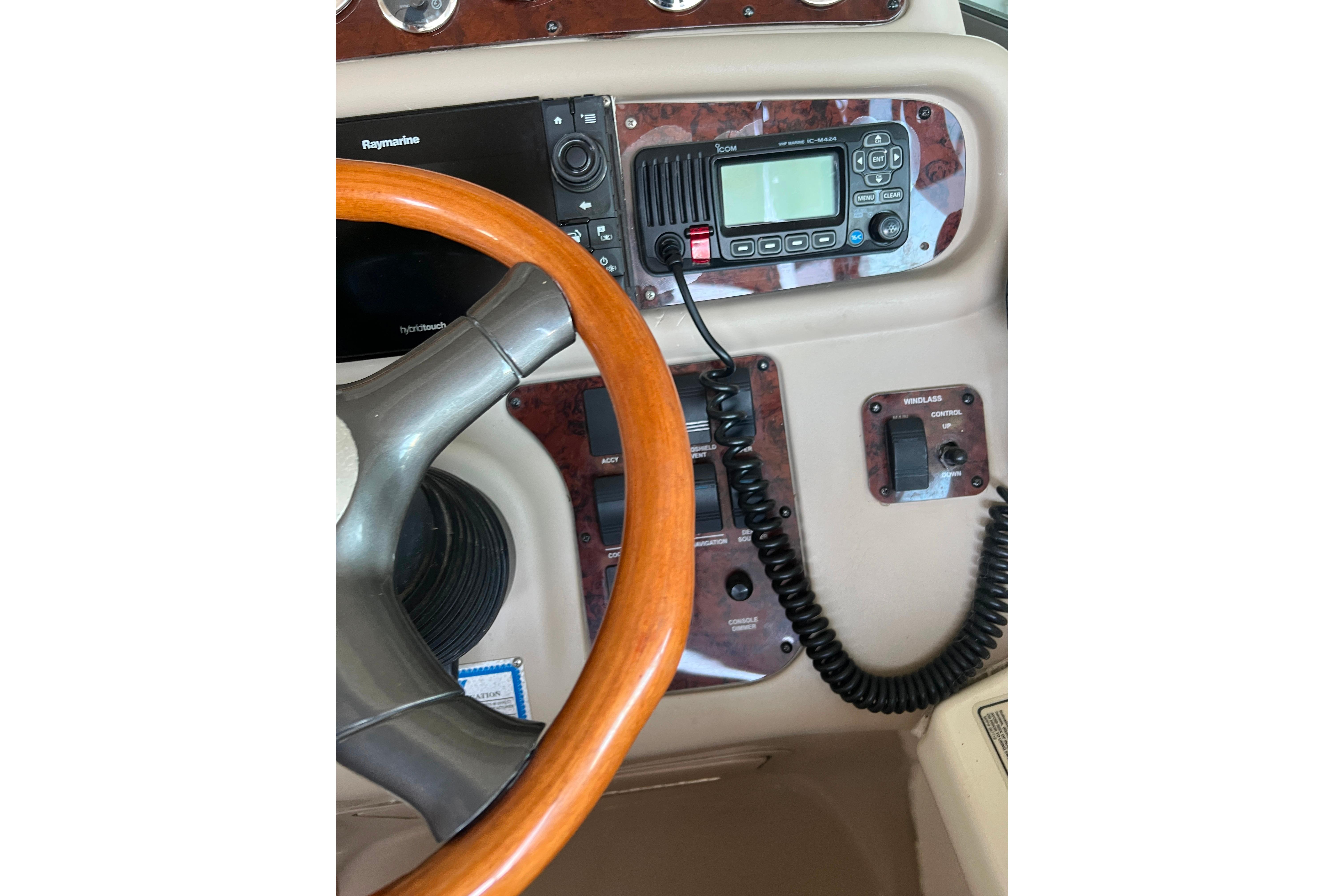 1999 Sea Ray 290 Sundancer helm with steering wheel and navigation controls.