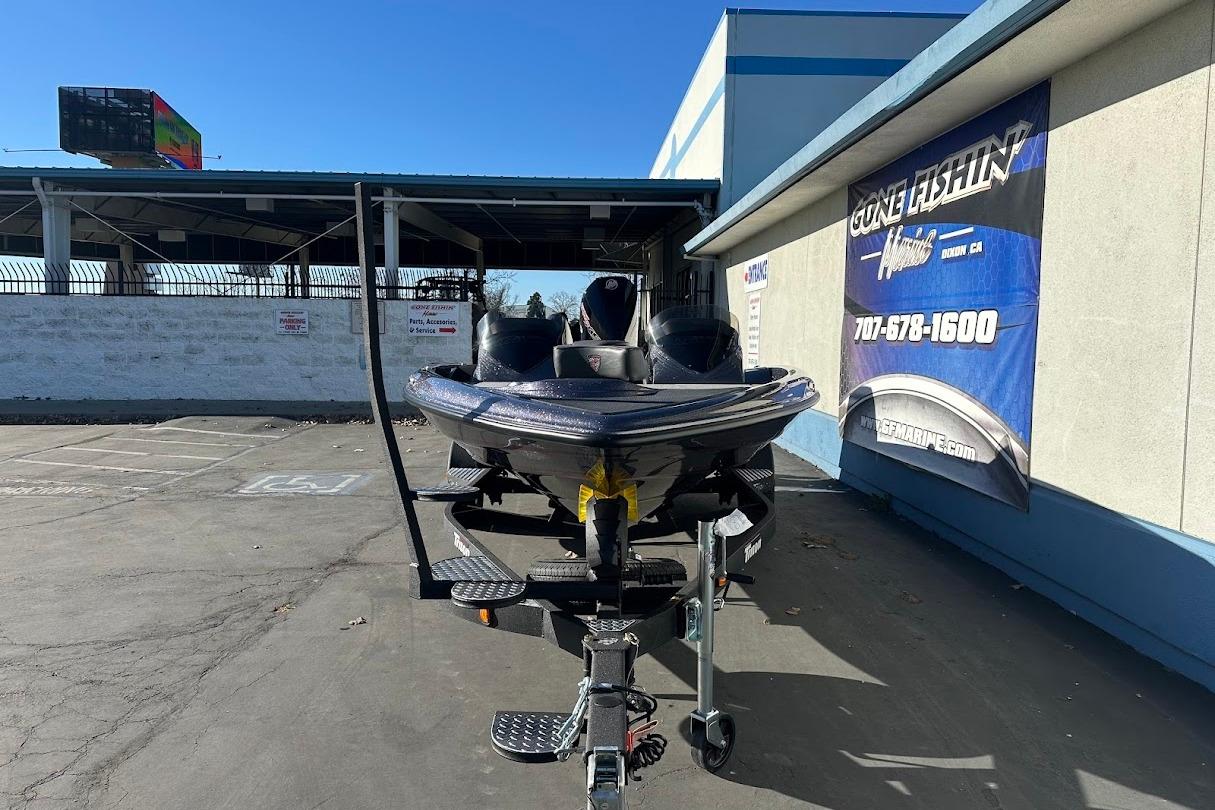 2026 Triton 18 TrX boat on trailer outside dealership, sunny day.