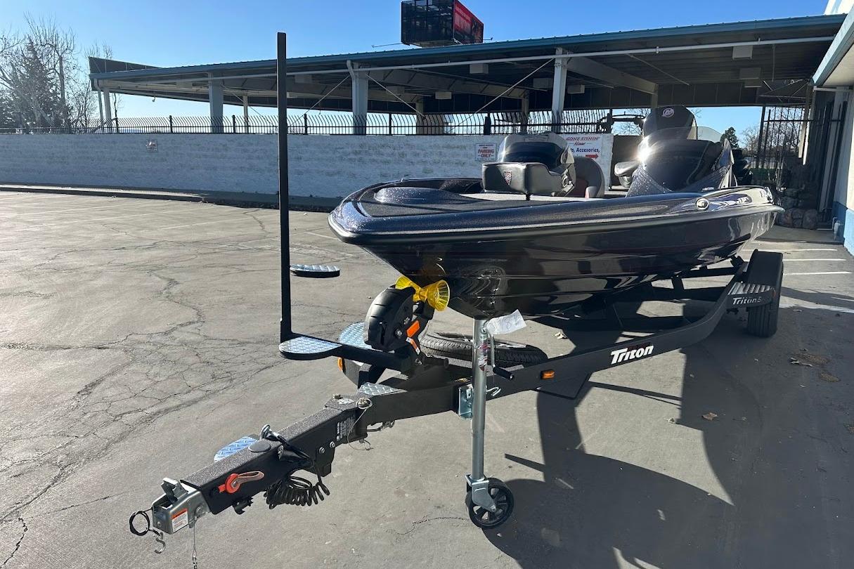 2026 Triton 18 TrX boat on trailer in sunny parking lot.
