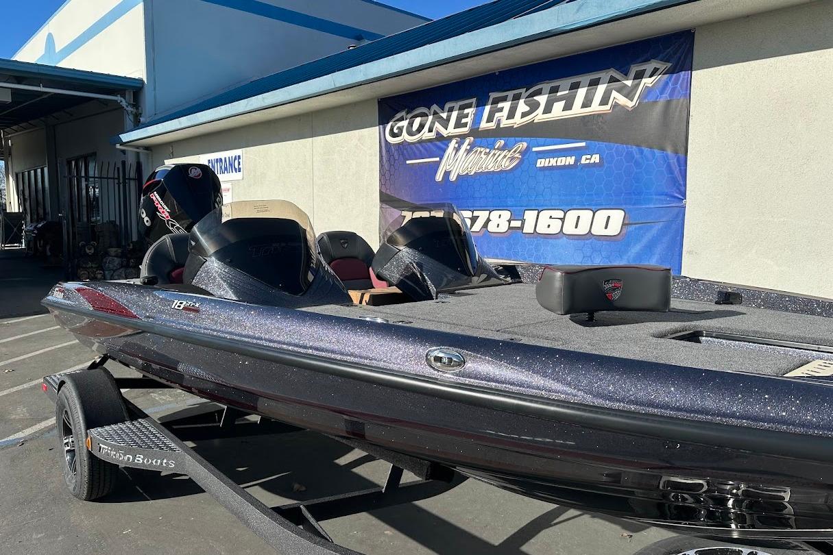 2026 Triton 18 TrX boat displayed at dealership, featuring sleek design and modern features.