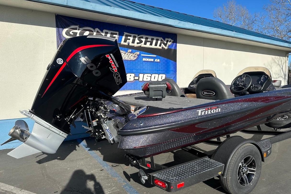 2026 Triton 18 TrX boat with powerful engine, parked outside dealership.