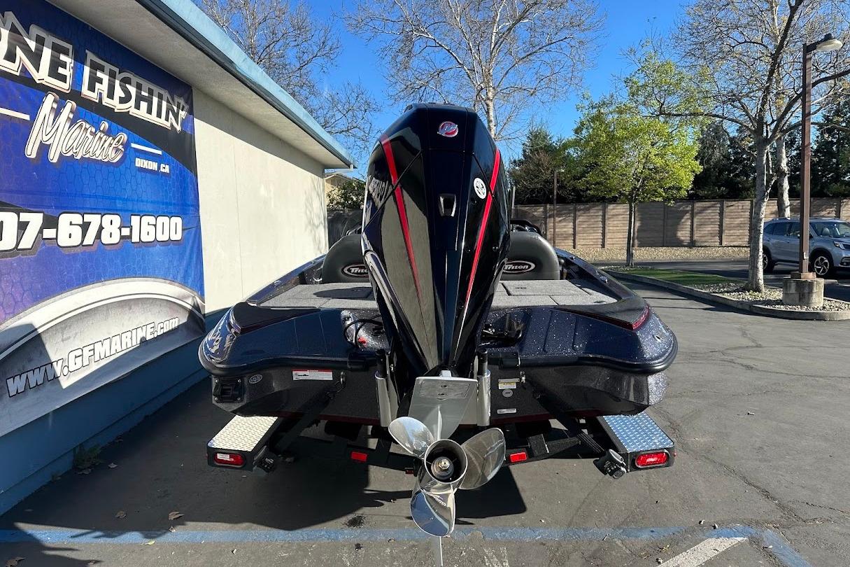 2026 Triton 18 TrX boat parked at a marine dealership, rear view.