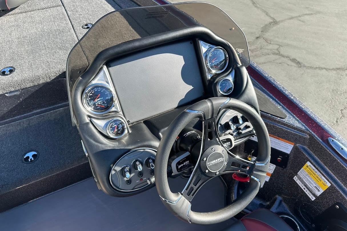 2026 Triton 18 TrX boat dashboard with steering wheel and gauges.