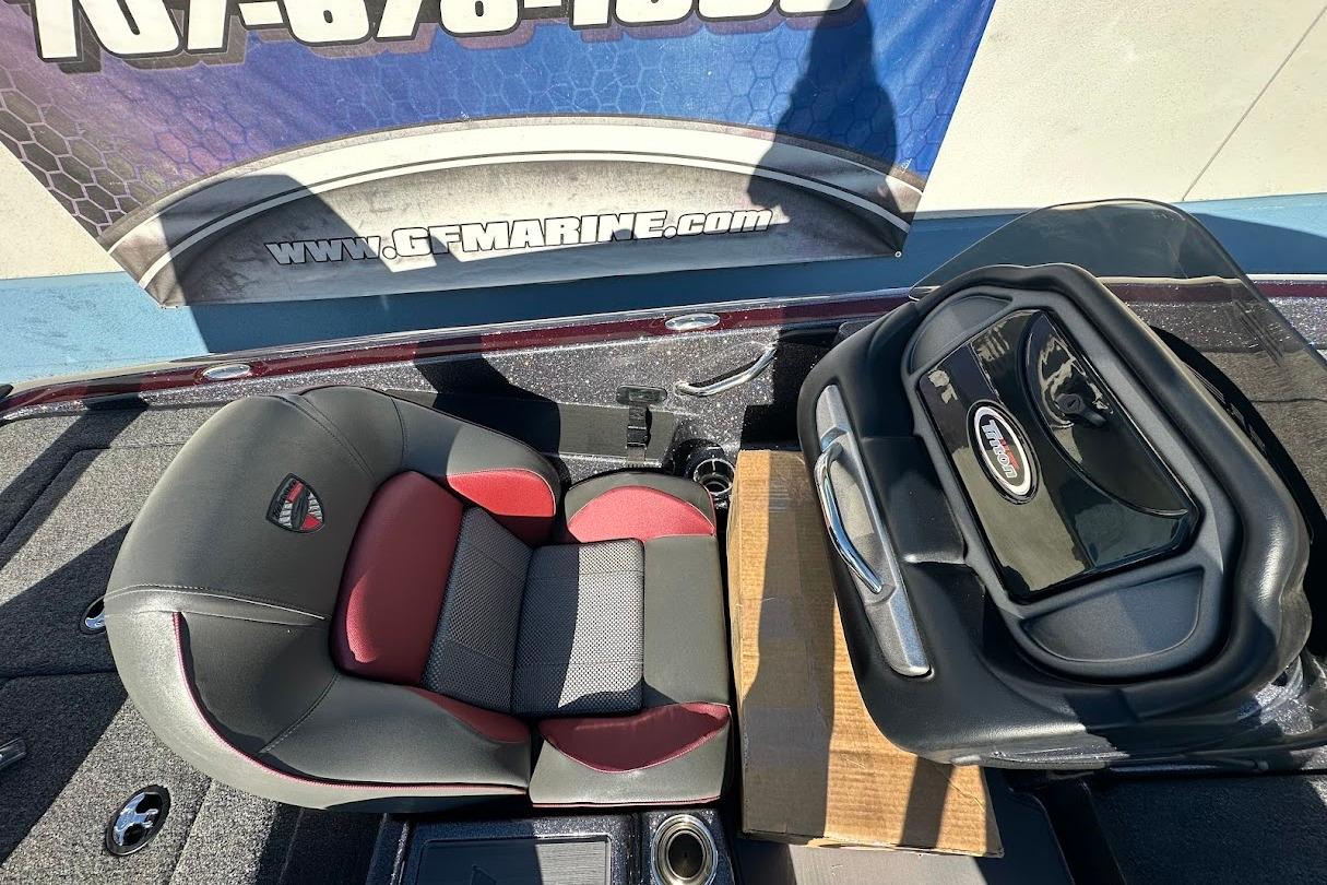 2026 Triton 18 TrX boat interior with red and black seating and storage compartment.