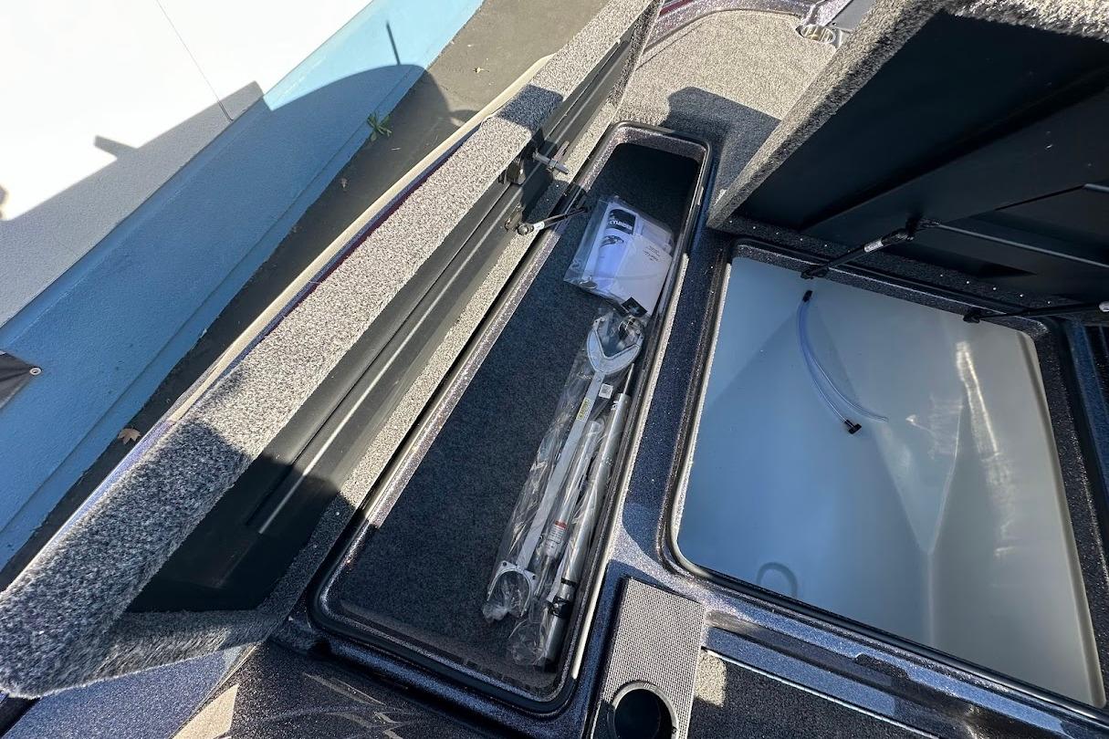 2026 Triton 18 TrX boat storage compartments with tools and accessories.