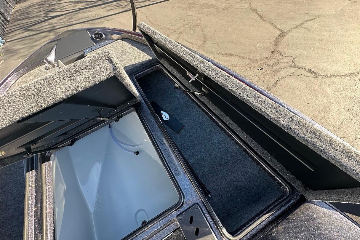 Open storage compartments on 2026 Triton 18 TrX boat, showcasing interior space.