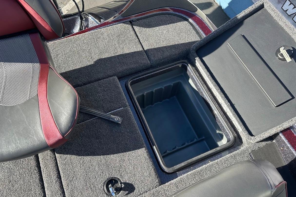 2026 Triton 18 TrX boat interior with open storage compartment and cushioned seat.