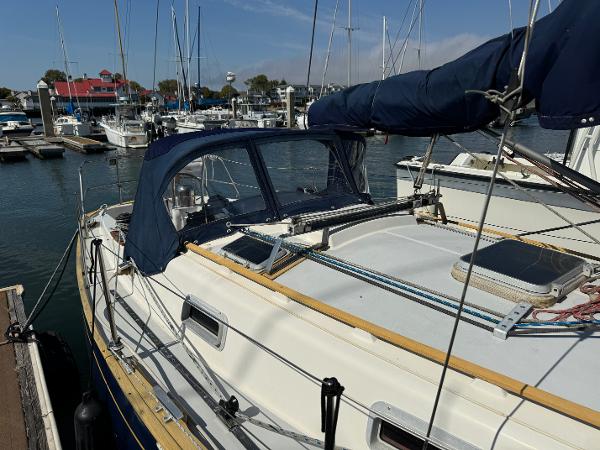 1990 Contessa 32 sailboat docked in marina.
