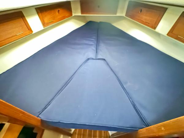 Interior of a 1990 Contessa 32 yacht with blue mattress.