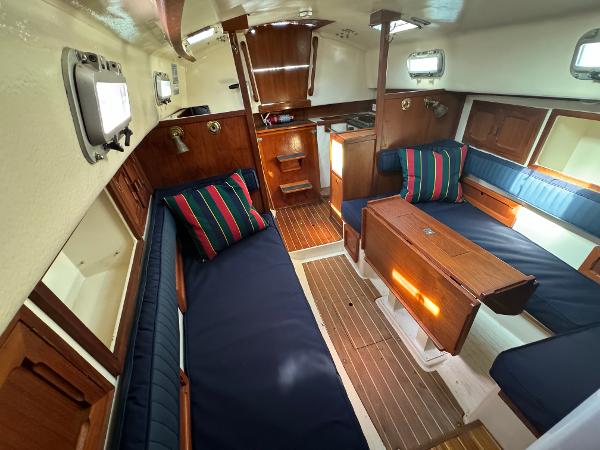 Interior of a 1990 Contessa 32 yacht with wooden furnishings.