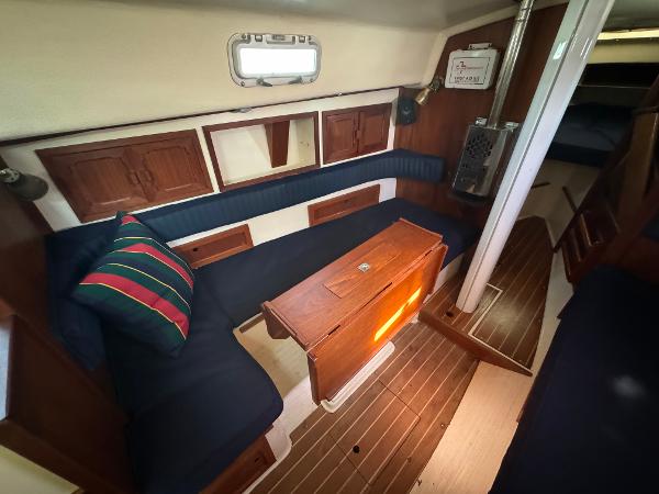 Interior of a 1990 Contessa 32 yacht with wooden furnishings.