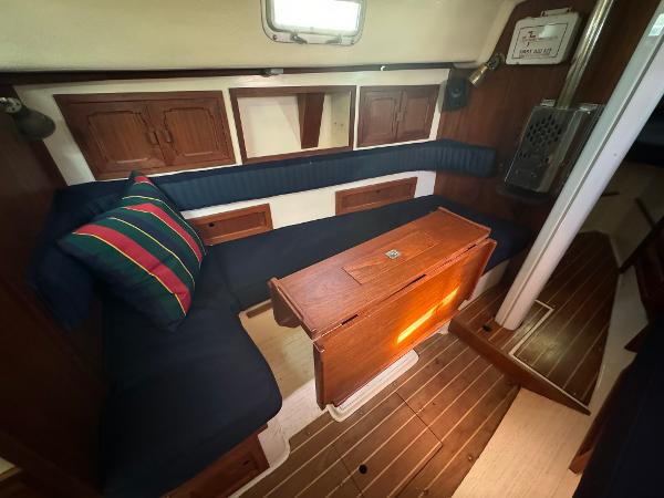 Interior of a 1990 Contessa 32 yacht with wooden furnishings.