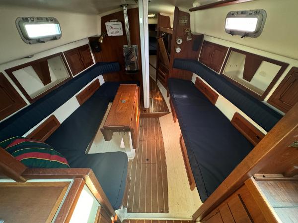 Interior of a 1990 Contessa 32 yacht with wooden furnishings.