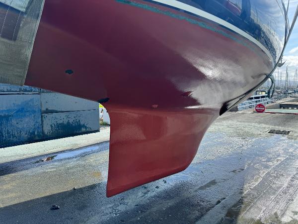 Hull of a 1990 Contessa 32 sailboat in dry dock.