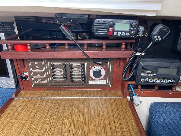 Control panel of a 1984 Catalina 30 sailboat with radio equipment and switches.