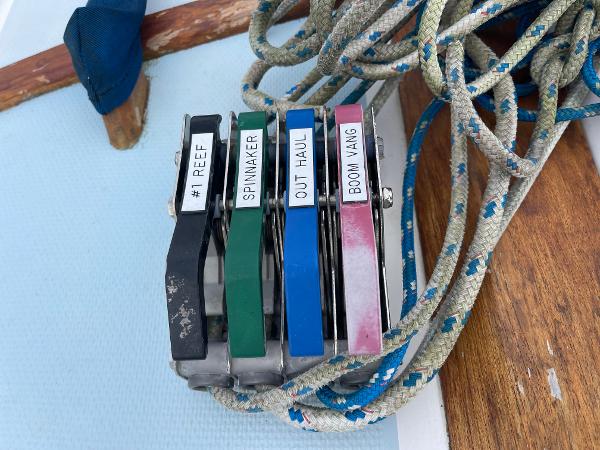 Sailing control lines on a 1984 Catalina 30, labeled for reef, spinnaker, outhaul, and boom vang.