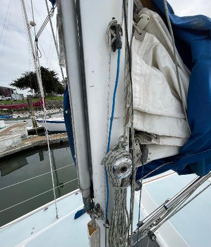 Close-up of a 1984 Catalina 30 sailboat mast and rigging at a marina.
