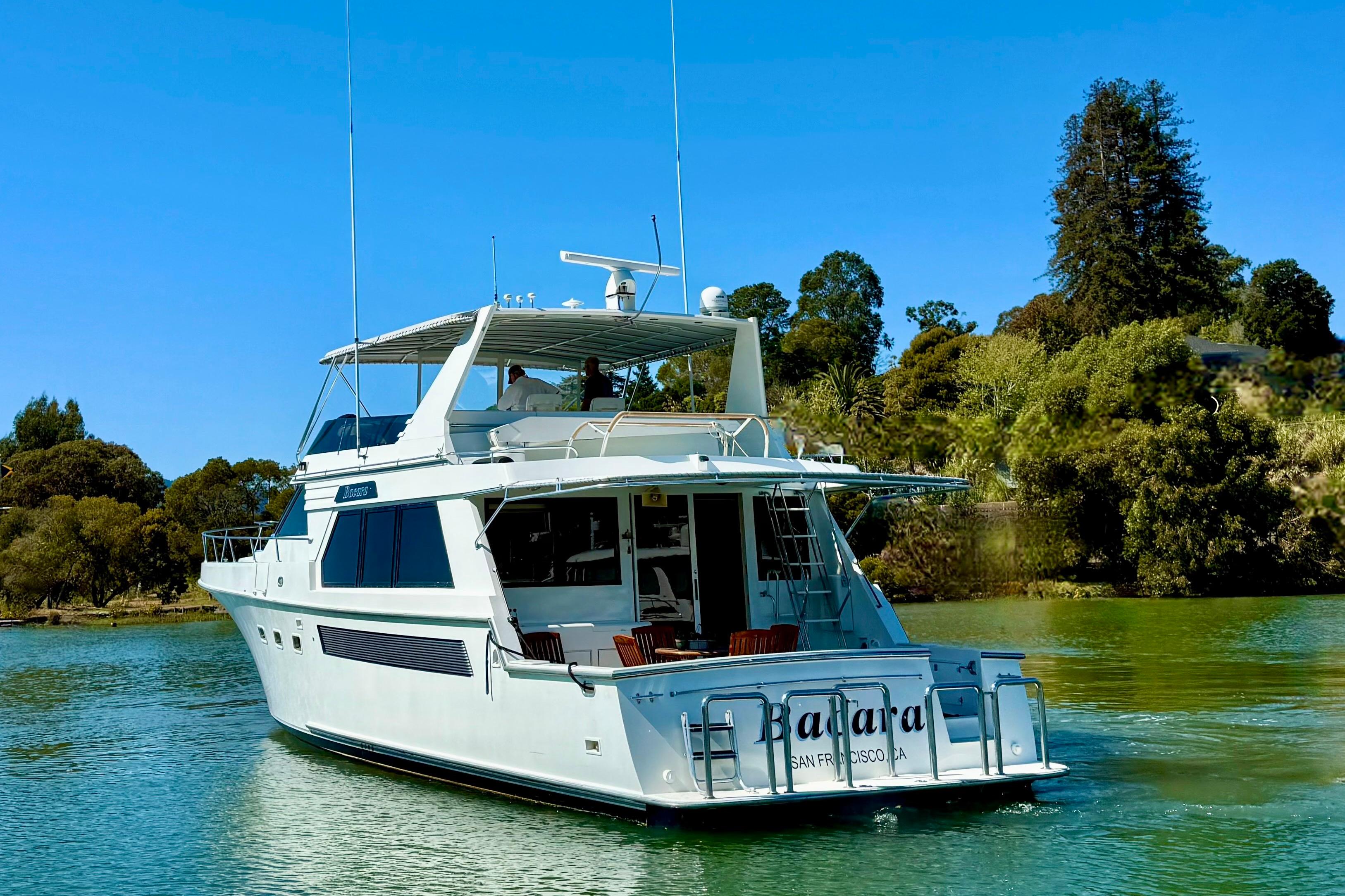 1993 Tollycraft 57 Pilothouse Motor Yacht cruising on a serene waterway.