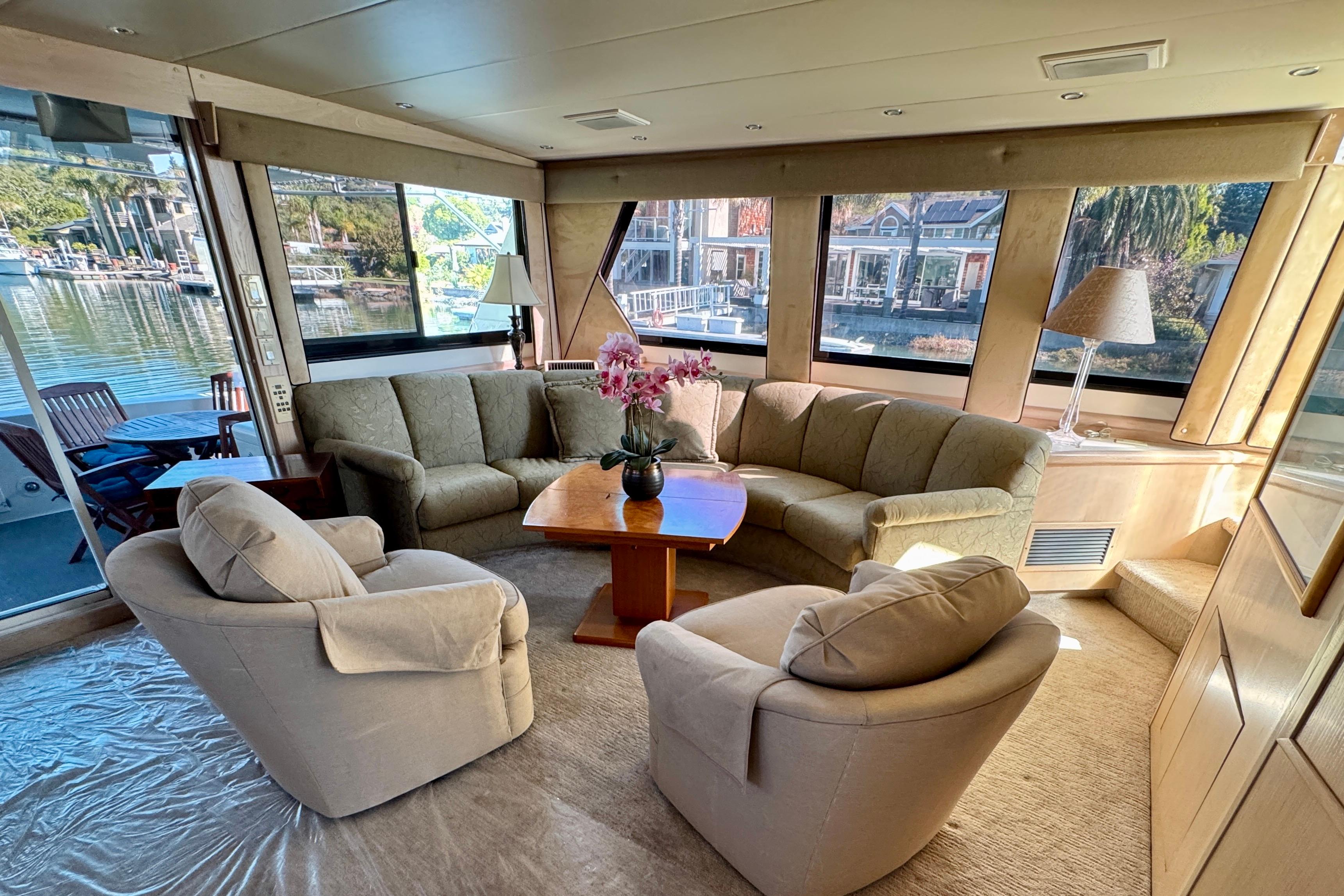 Luxurious interior of 1993 Tollycraft 57 Pilothouse Motor Yacht with elegant seating and scenic views.