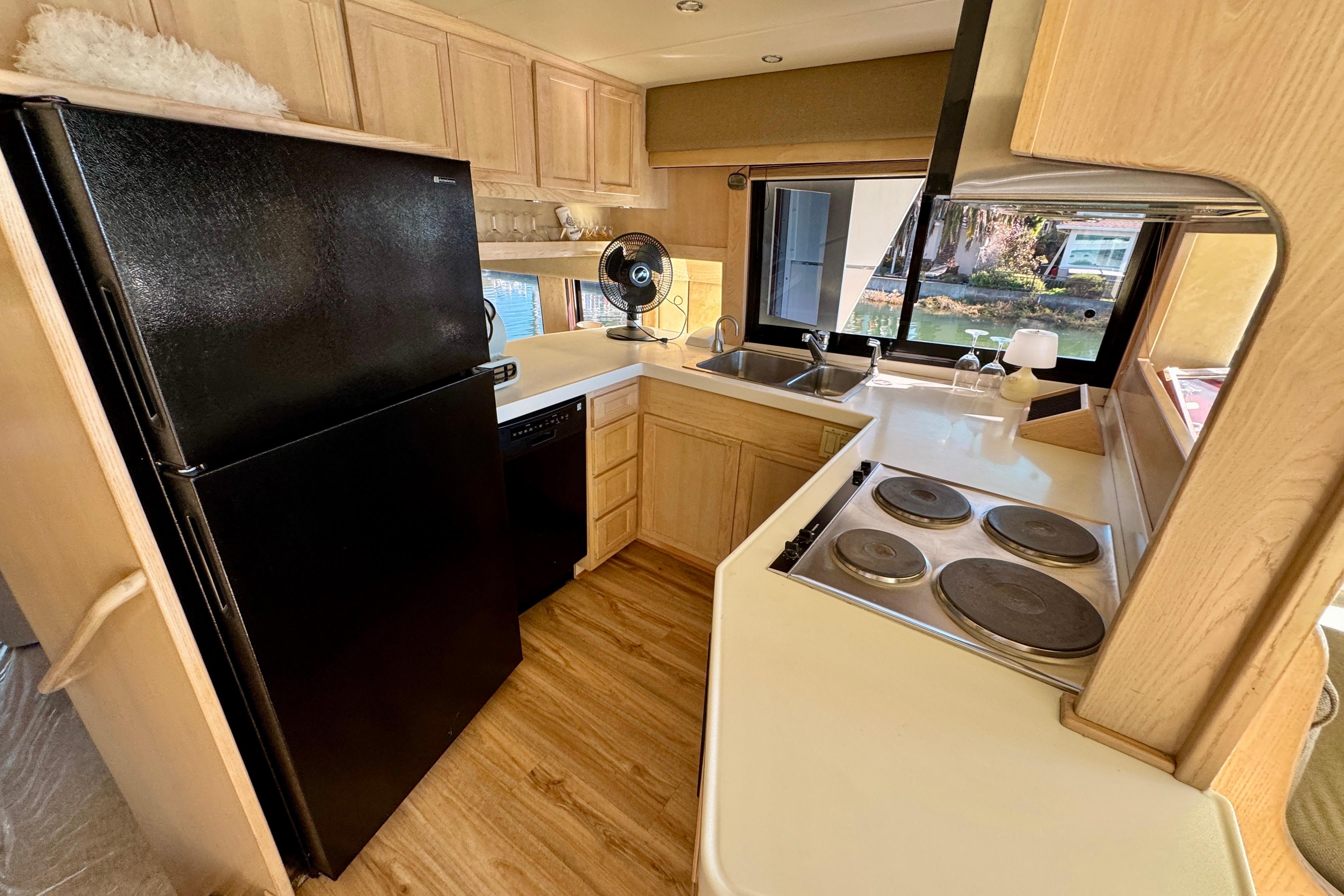 Kitchen interior of 1993 Tollycraft 57 Pilothouse Motor Yacht with modern appliances.
