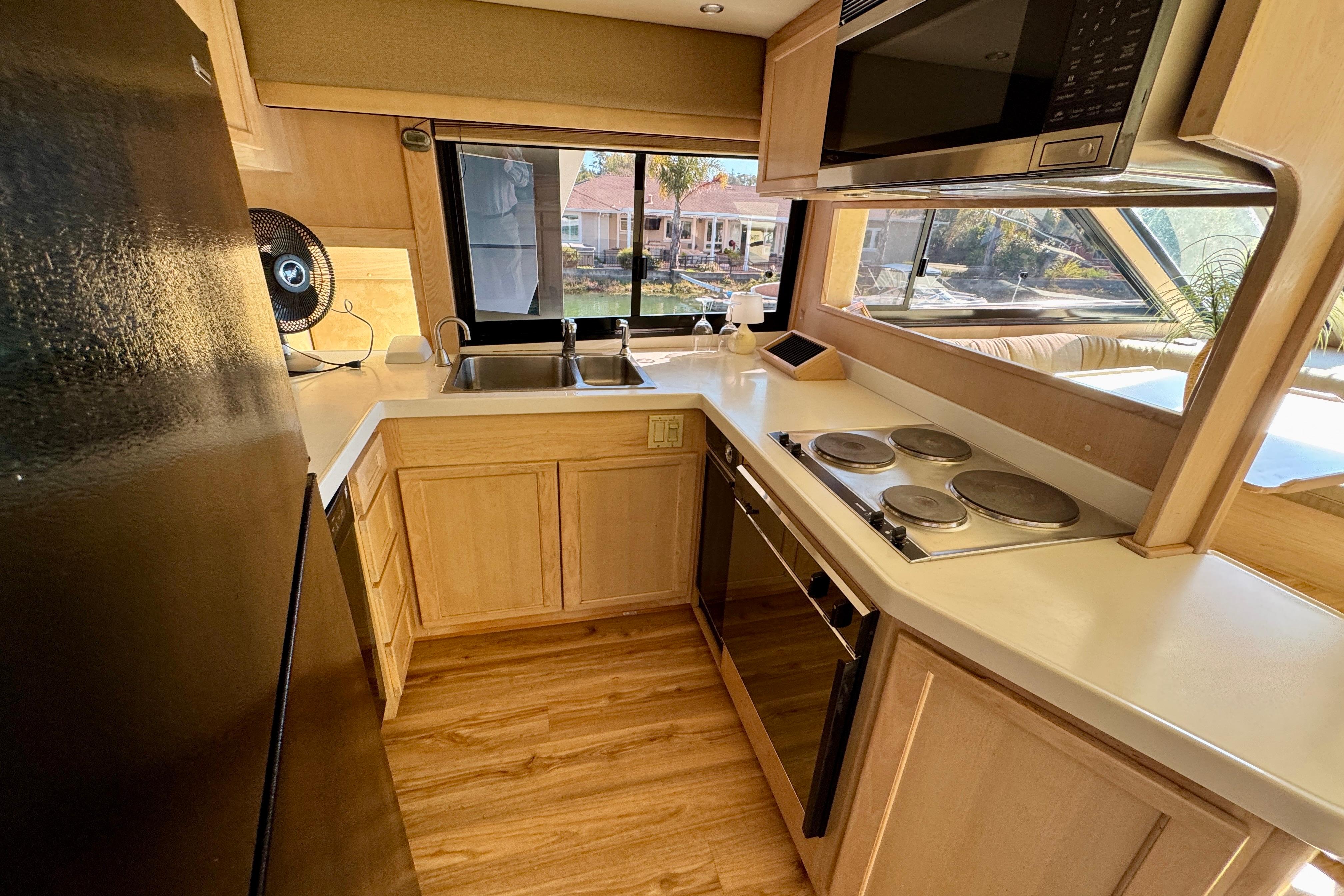 1993 Tollycraft 57 Pilothouse Motor Yacht kitchen with modern appliances and wood cabinetry.