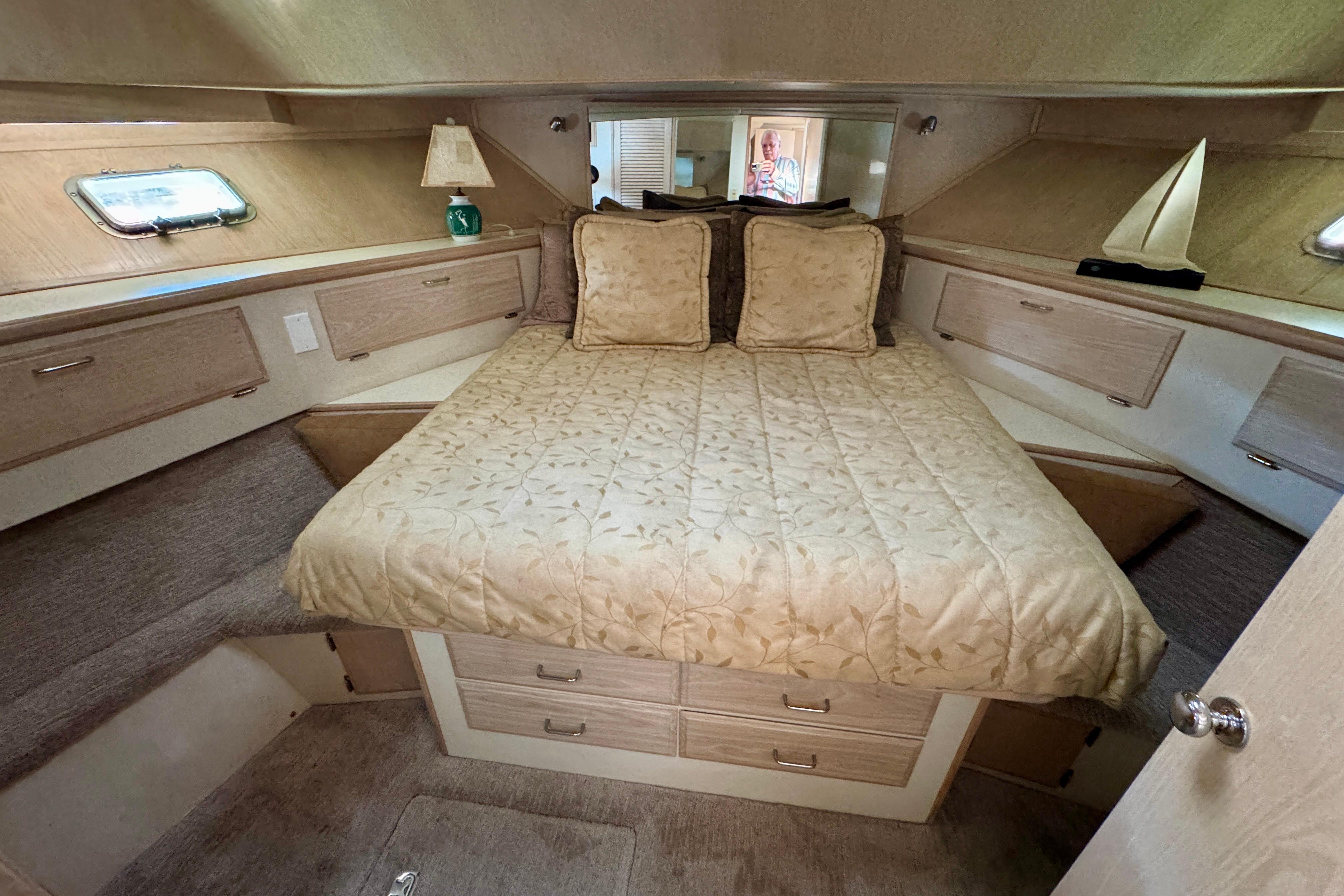 Luxurious 1993 Tollycraft 57 Pilothouse Motor Yacht bedroom with cozy bedding and elegant decor.