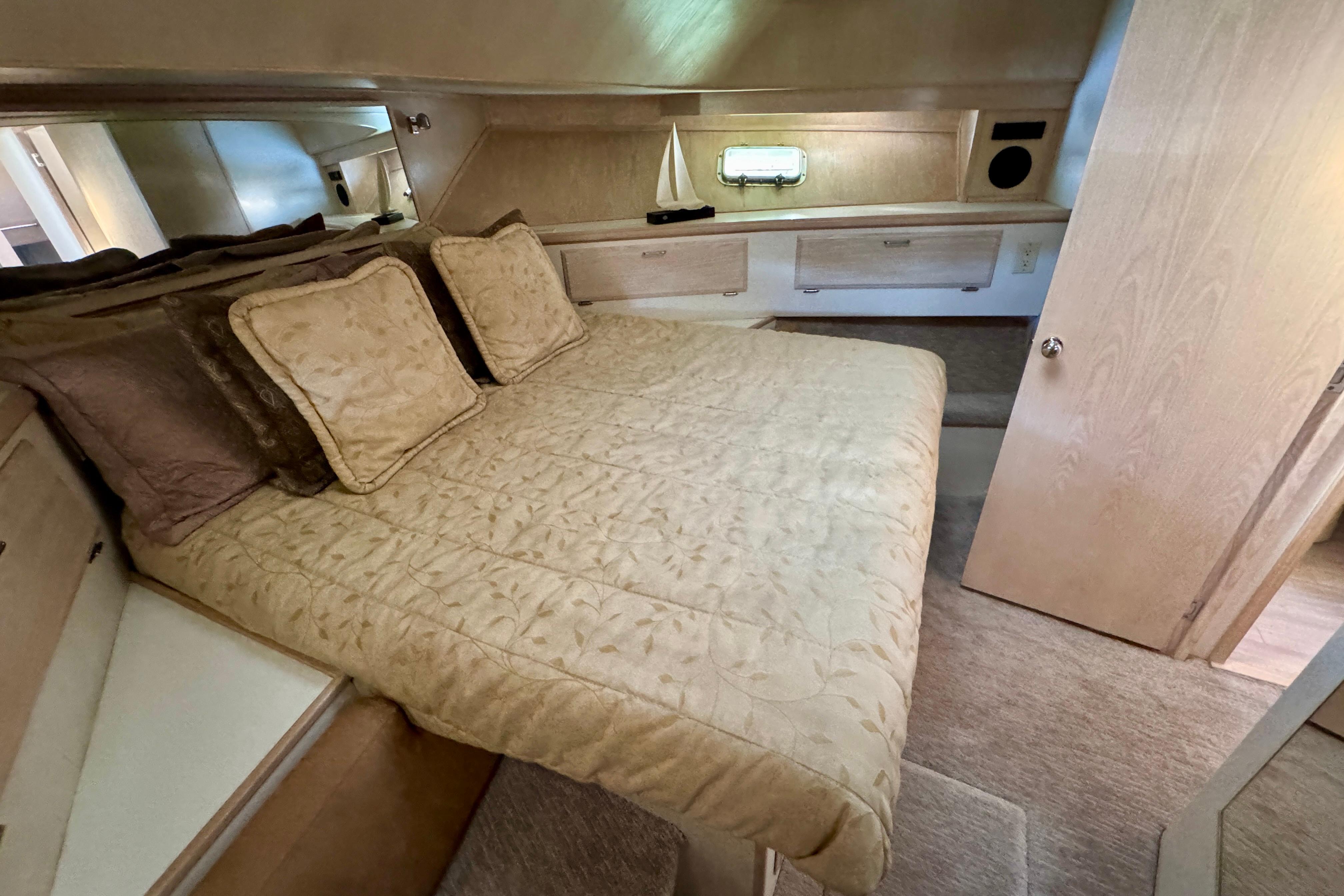 Luxurious bedroom interior of 1993 Tollycraft 57 Pilothouse Motor Yacht with elegant bedding.
