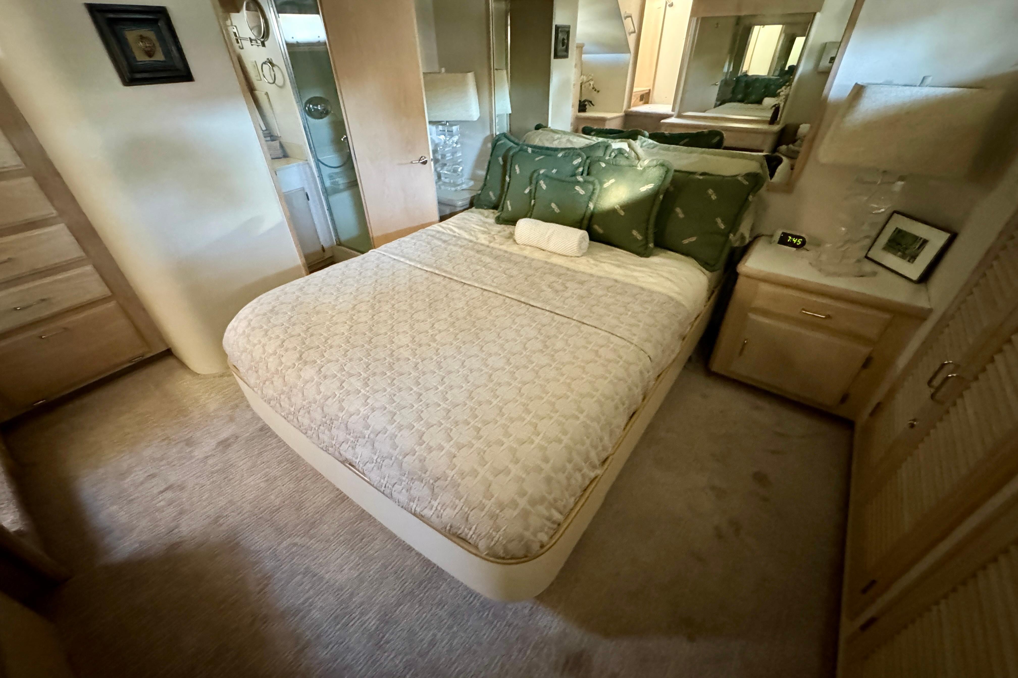 Cozy bedroom in 1993 Tollycraft 57 Pilothouse Motor Yacht with elegant decor and soft lighting.