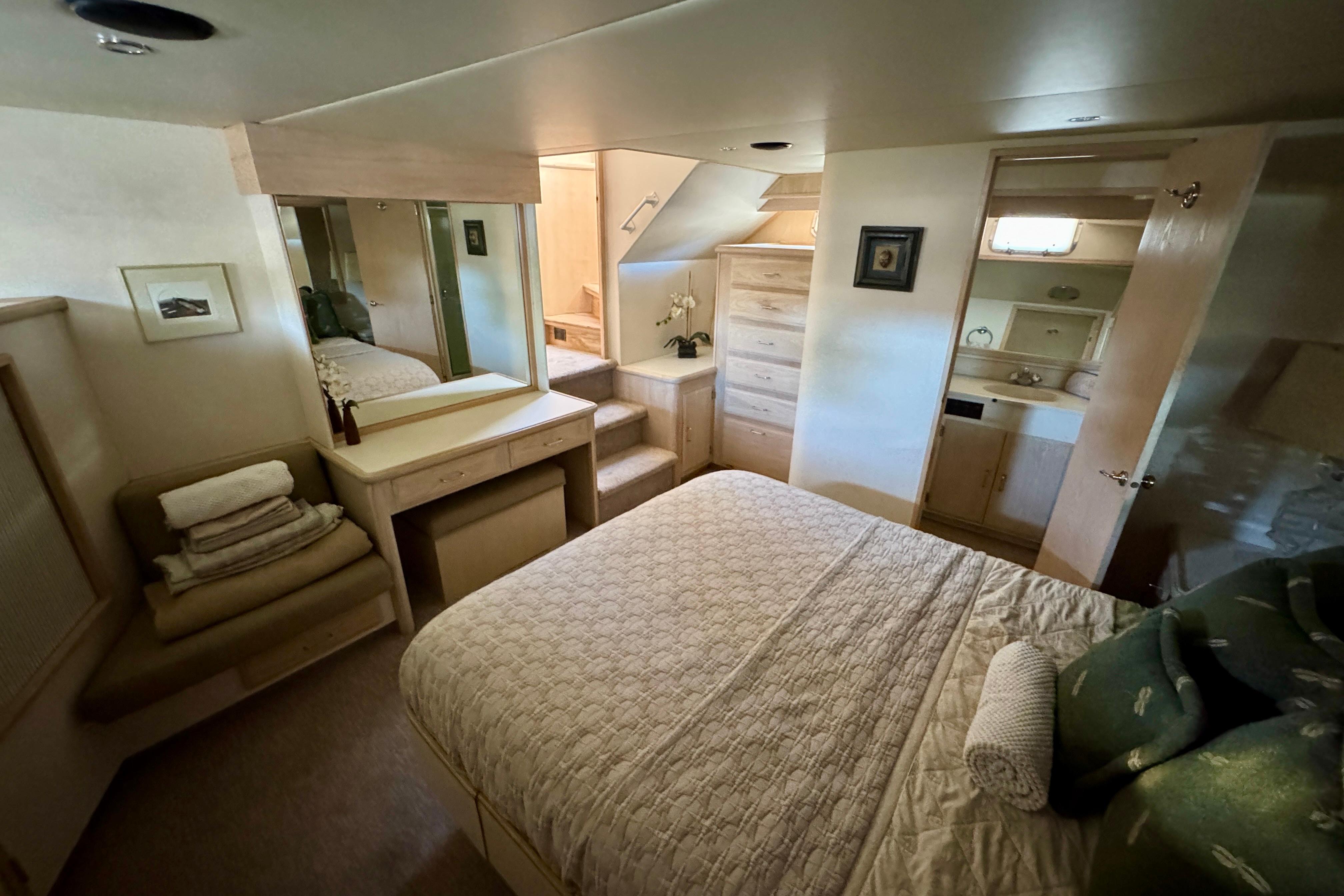 Luxurious bedroom interior of 1993 Tollycraft 57 Pilothouse Motor Yacht with elegant furnishings.