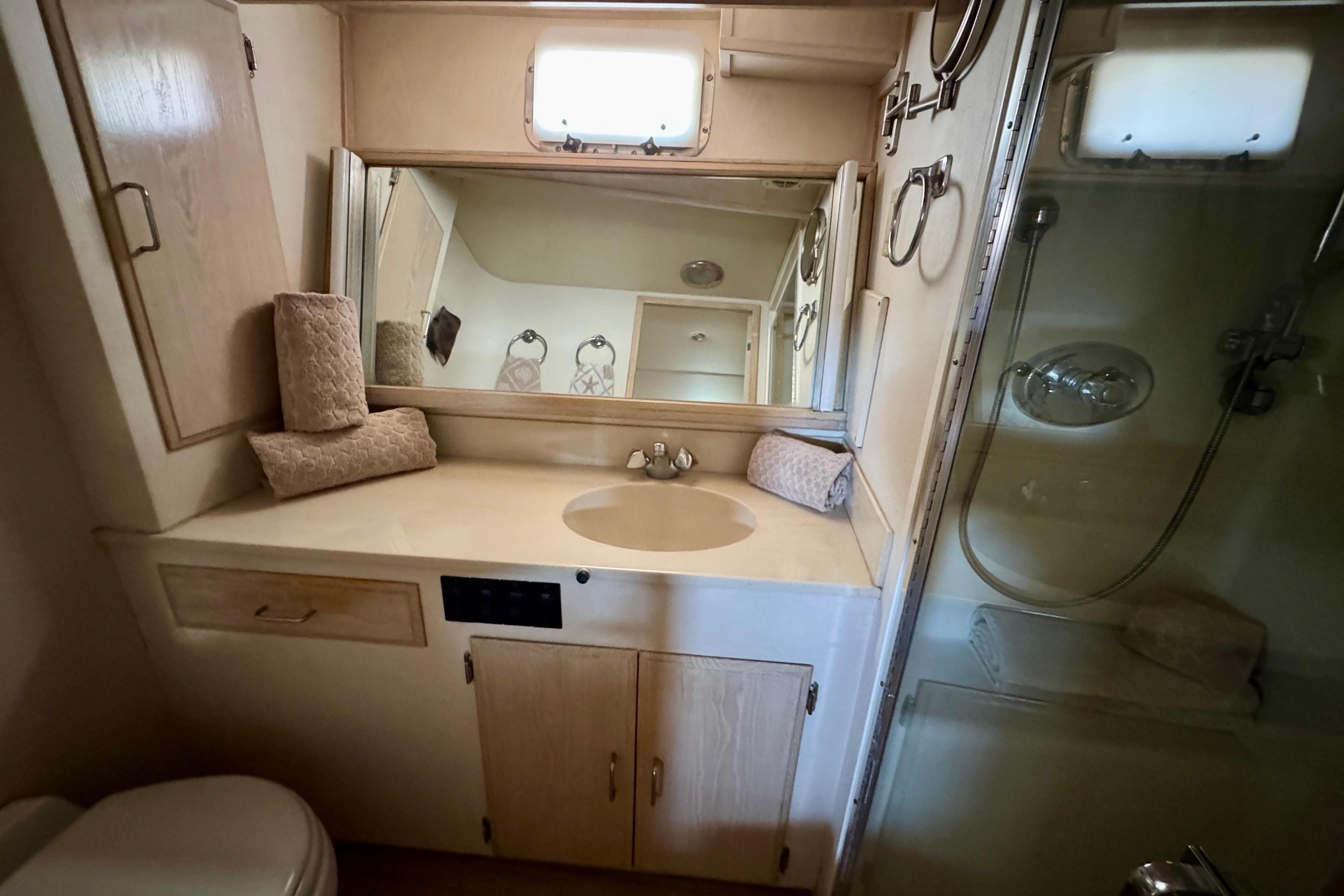 Bathroom interior of 1993 Tollycraft 57 Pilothouse Motor Yacht with sink and shower.