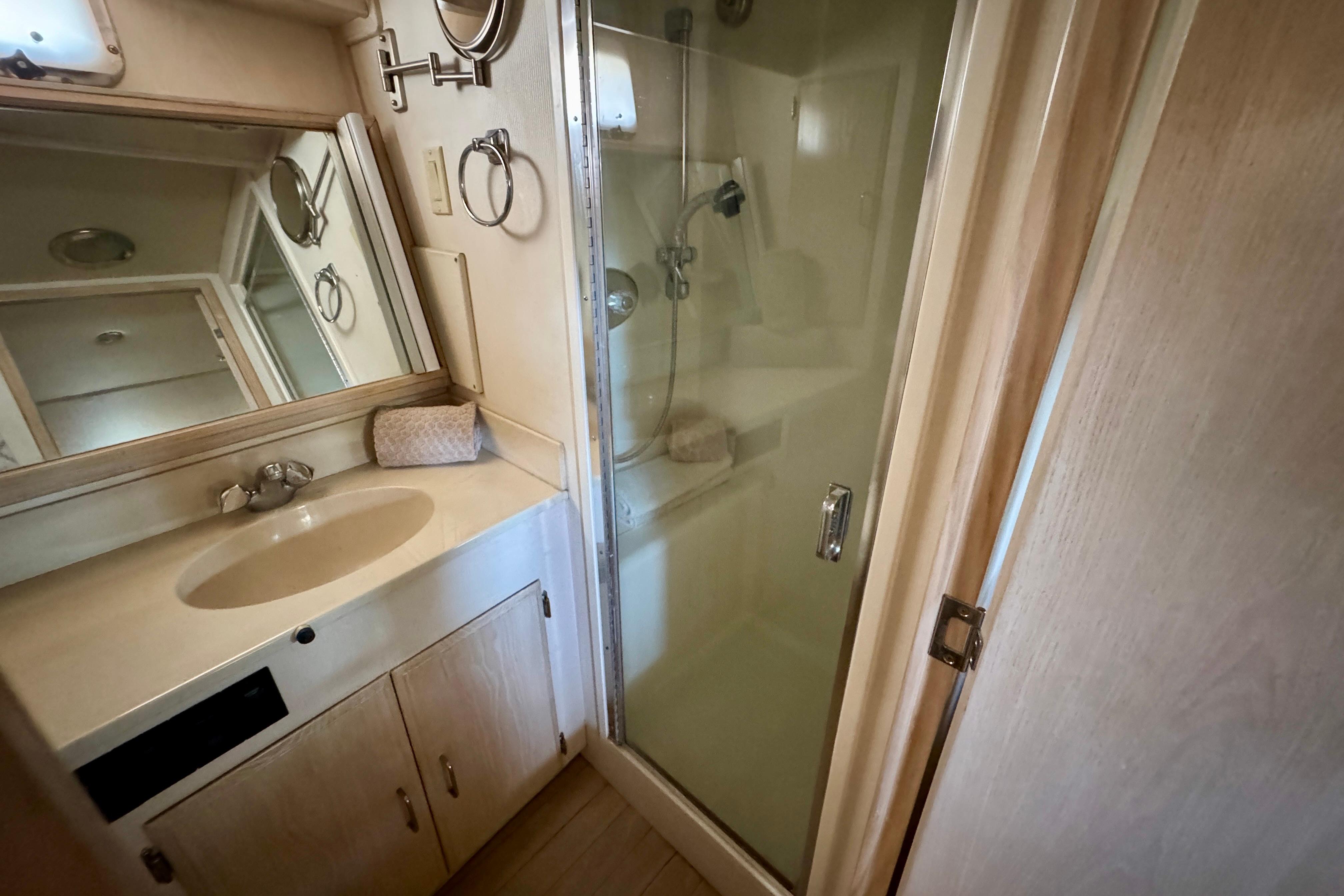Bathroom interior of 1993 Tollycraft 57 Pilothouse Motor Yacht with shower and vanity.