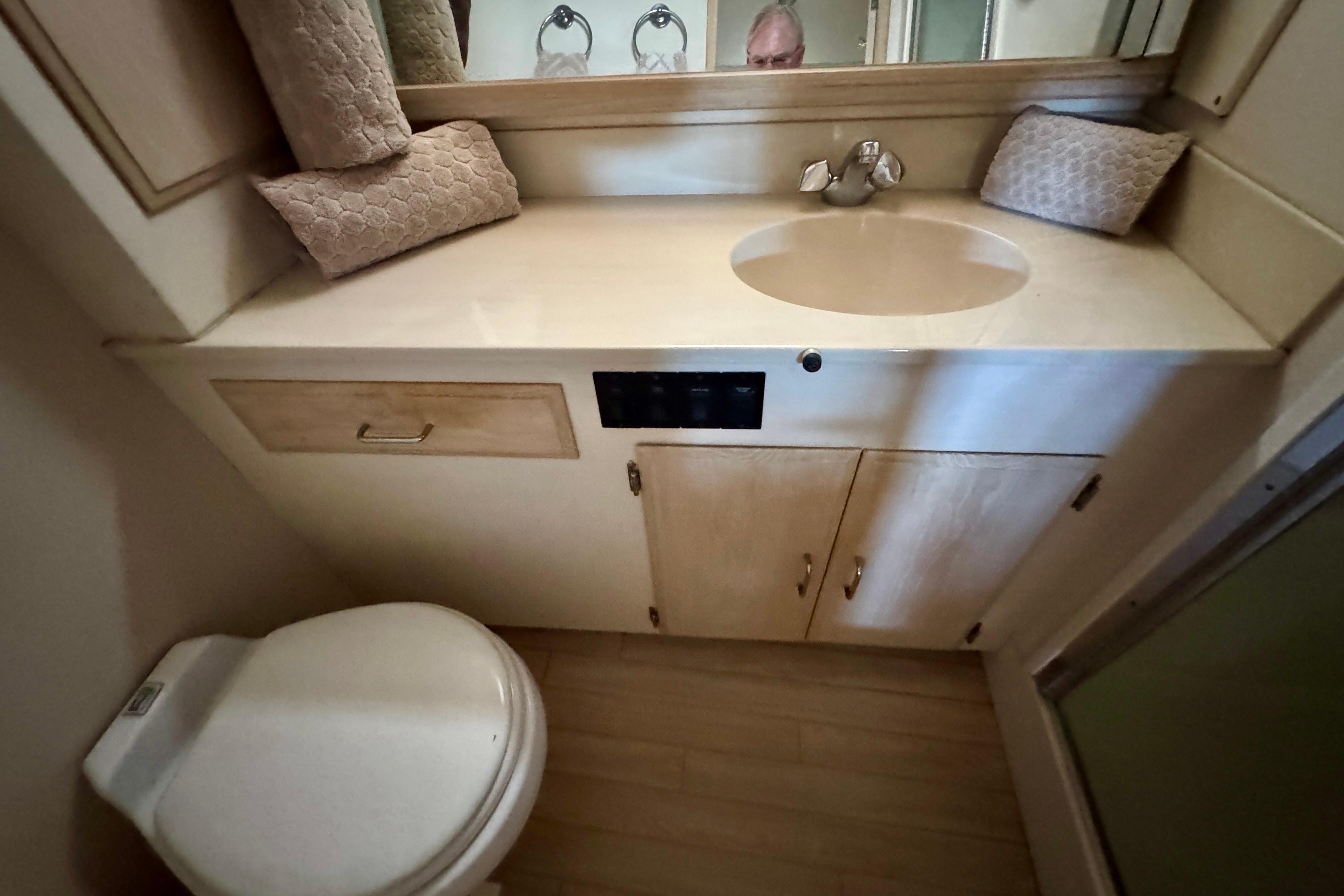 Bathroom interior of 1993 Tollycraft 57 Pilothouse Motor Yacht, featuring sink and toilet.
