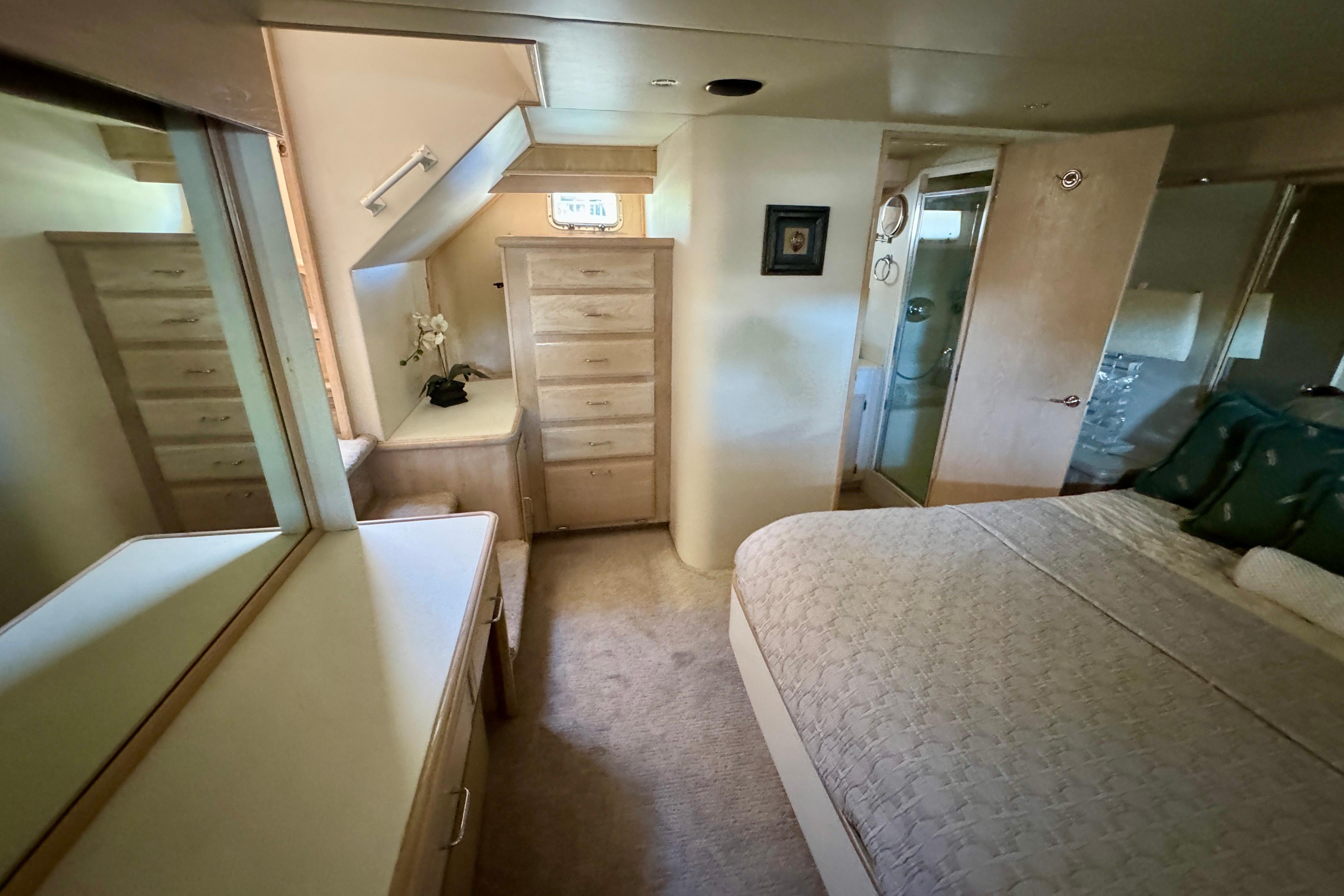 Luxurious bedroom interior of 1993 Tollycraft 57 Pilothouse Motor Yacht with elegant furnishings.