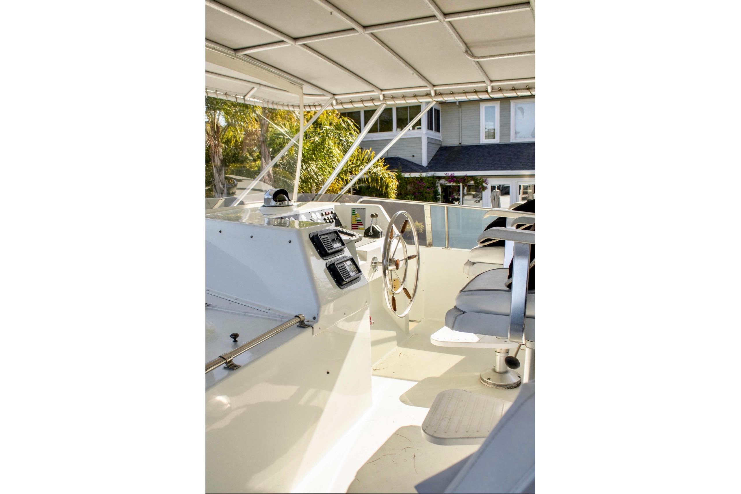 1993 Tollycraft 57 Pilothouse Motor Yacht helm with steering wheel and navigation equipment.