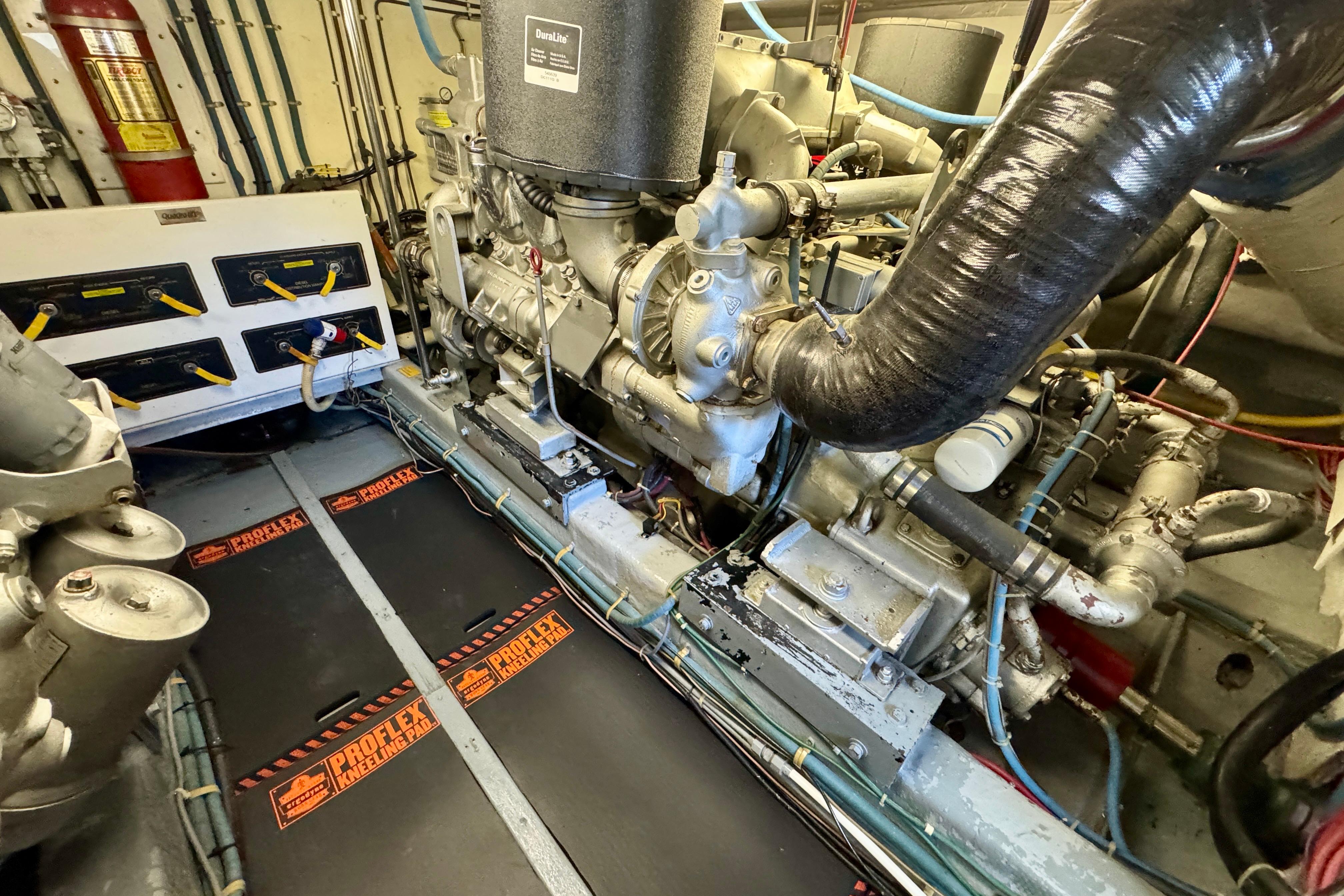 Engine room of 1993 Tollycraft 57 Pilothouse Motor Yacht, showcasing machinery and equipment.