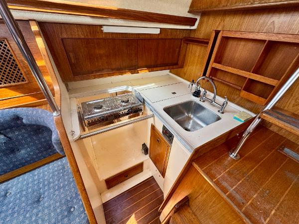 1984 Camper & Nicholsons Nicholson 35 yacht interior kitchen with stove and sink.