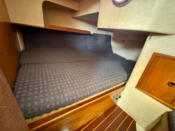 Cozy cabin interior of 1984 Camper & Nicholsons Nicholson 35 sailboat with wooden accents.